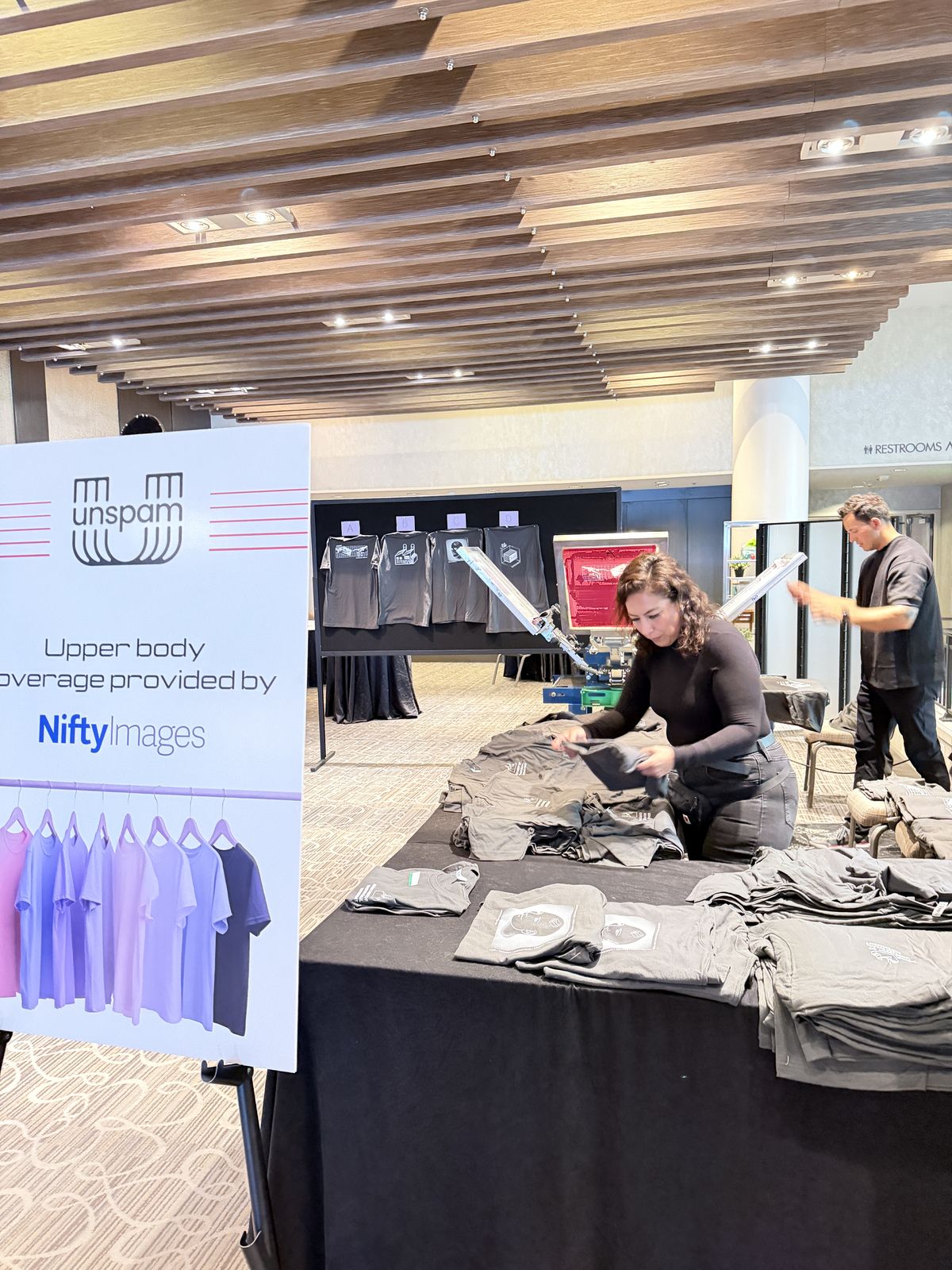 Live shirt pressing table add-on running beside a party hat bar